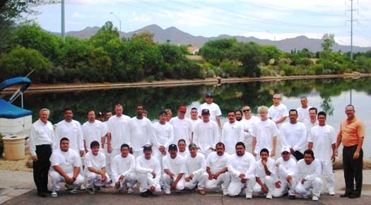 Painters take a break from classroom work for a group photo.